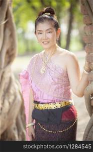 beautiful asian woman wearing thai tradition clothes toothy smiling face in ayutthaya world heritage site of unesco