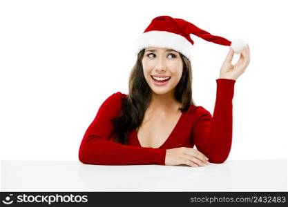 Beautiful asian woman with a thinking expression and wearing Santa’s hat,  isolated on white