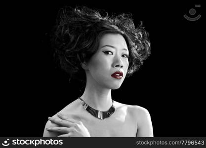 Beautiful Asian woman with red lips and bare shoulders in black and white, isolated