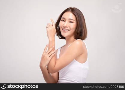 Beautiful Asian woman with short hair looking at camera smile with clean and fresh skin Happiness and cheerful with positive emotional,isolated on gray background,Beauty and Cosmetics Concept