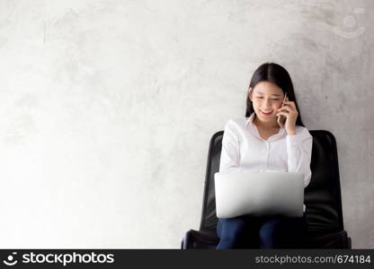 Beautiful asian young businesswoman excited and glad of success with laptop, girl taking mobile phone and working coffee shop on cement background, career freelance business concept.