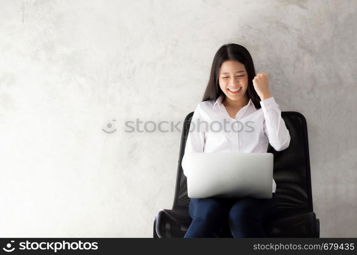 Beautiful asian young woman excited and glad of success with laptop, girl working coffee shop on cement background, career freelance business concept.