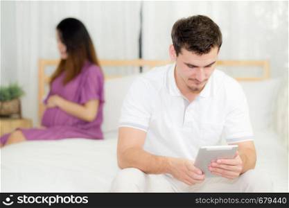 Beautiful asian young woman pregnant and husband with tablet with problem relationship, unhappy and stress, family with abortion concept.