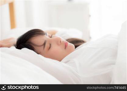 Beautiful asian young woman sleeping lying in bed with head on pillow comfortable and happy. girl with relax for health concept.