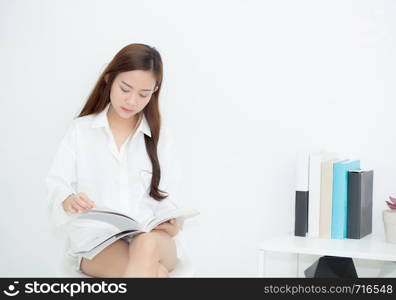 Beautiful asian young woman smile with happy reading a book, girl leisure with magazine, education concept.