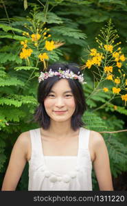 Beautiful asian young woman with a crown of flowers