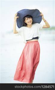 beautiful asian younger woman smiling with happiness on vacation sea beach