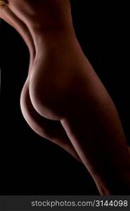 Beautiful ass of young woman over dark background