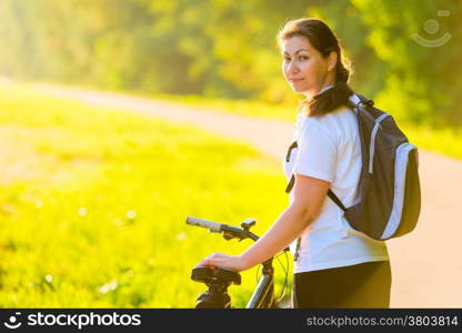 beautiful athlete with a backpack on a bicycle