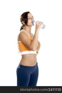 Beautiful athletic girl isolated on white drinking water