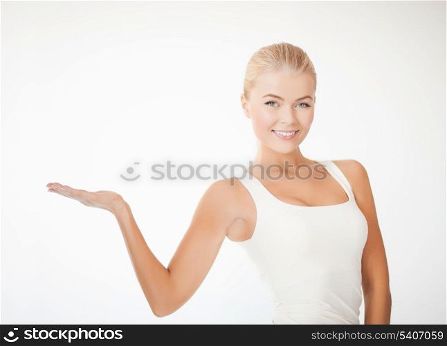 beautiful athletic woman in sportswear with empty hand