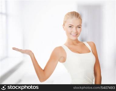 beautiful athletic woman in sportswear with empty hand