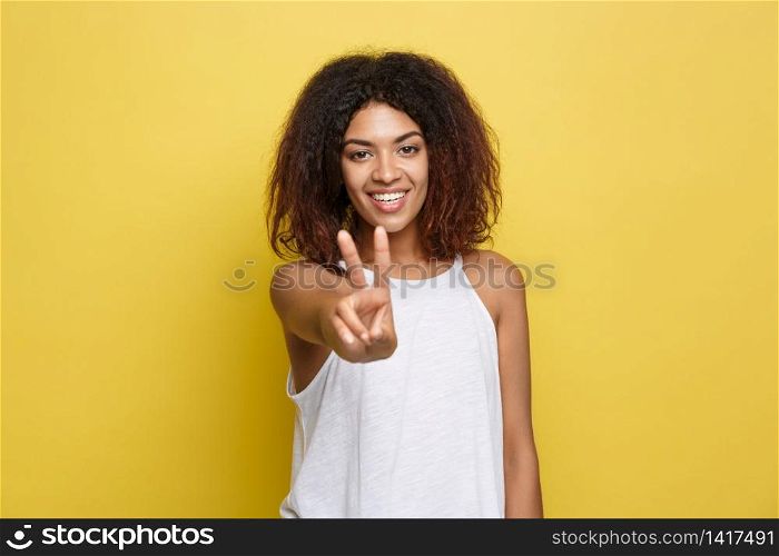 Beautiful attractive African American woman with trendy glasses posting over yellow studio background. Copy Space. Beautiful attractive African American woman with trendy glasses posting over yellow studio background. Copy Space.