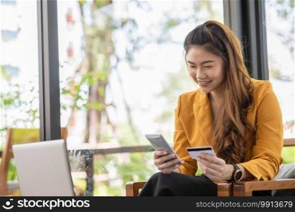 Beautiful Attractive Asian woman using credit card for shopping online transform to online payment feeling so enjoy and happiness,Shopping concept