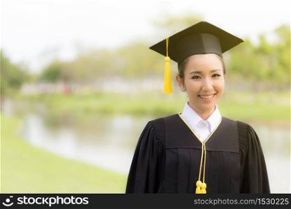 Beautiful Attractive Asian women graduate in graduation cap smile and feeling so proud and happiness with a copy space,Education Success Concept