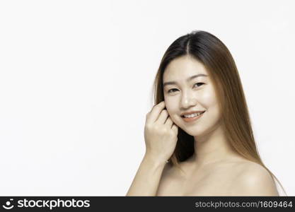 Beautiful Attractive Charming Asian young woman smile with white teeth and touching soft cheek feeling so happy and cheerful with healthy skin,isolated on white background,Beauty Cosmetology Concept