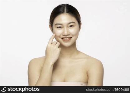 Beautiful Attractive Charming Asian young woman smile with white teeth and touching soft cheek feeling so happy and cheerful with healthy skin,isolated on white background,Beauty Cosmetology Concept