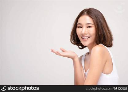 Beautiful Attractive Charming Asian young woman smile with white teeth open hand palm for display cosmetics product cheerful with healthy skin,isolated on white background,Beauty Cosmetics Concept