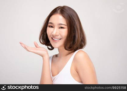 Beautiful Attractive Charming Asian young woman smile with white teeth open hand palm for display cosmetics product cheerful with healthy skin,isolated on white background,Beauty Cosmetics Concept