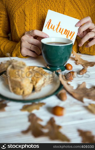 Beautiful autumn background - cup of tea, biscotti, autumn leaves and inscription Autumn