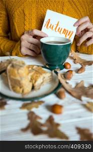 Beautiful autumn background - cup of tea, biscotti, autumn leaves and inscription Autumn