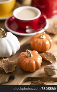 beautiful autumn background with pumpkins and a cup of coffee
