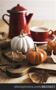 beautiful autumn background with pumpkins and a cup of coffee
