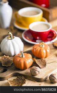 beautiful autumn background with pumpkins and a cup of coffee. autumn decor in the interior 