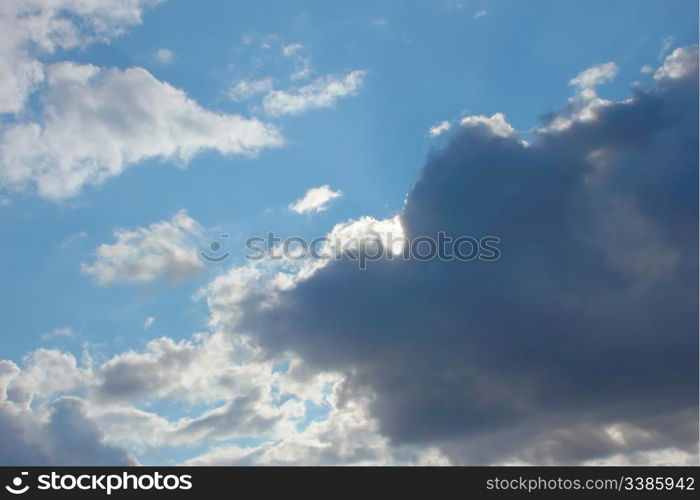 Beautiful autumn cloudscape, dark grey and white clouds on the blue sky