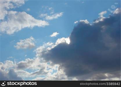 Beautiful autumn cloudscape, dark grey and white clouds on the blue sky