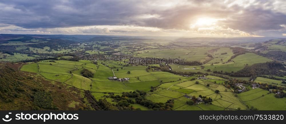 Beautiful Autumn Fall landscape aerial drone image of countryside view from Curbar Edge in Peak District England at sunset