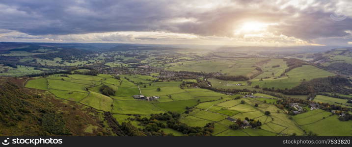 Beautiful Autumn Fall landscape aerial drone image of countryside view from Curbar Edge in Peak District England at sunset