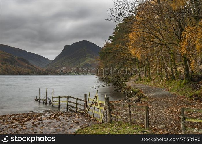 Beautiful Autumn Fall landscape image of Buttermere during moody Autumn Fall morning