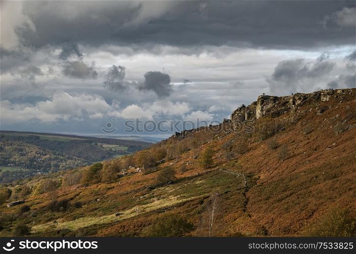 Beautiful Autumn Fall landscape image of Crubar Edge in Peak District at sunset with lovely evening light glow