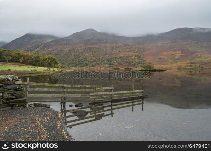 Beautiful Autumn Fall landscape image of Crummock Water at sunri. Stunning Autumn Fall landscape image of Crummock Water at sunrise in Lake District England