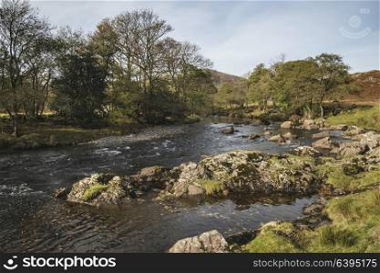 Beautiful Autumn Fall landscape image of river stream in Lake District in England