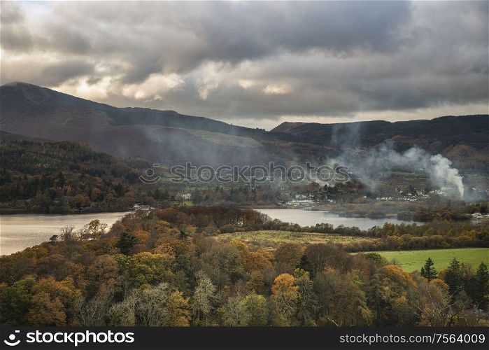 Beautiful Autumn Fall landscape image of view from Castlehead in Lake District over Derwentwater towards Catbells and Grisedale Pike at sunset with epic lighting in sky