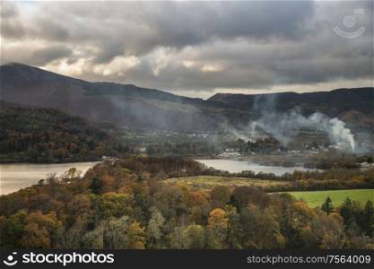 Beautiful Autumn Fall landscape image of view from Castlehead in Lake District over Derwentwater towards Catbells and Grisedale Pike at sunset with epic lighting in sky