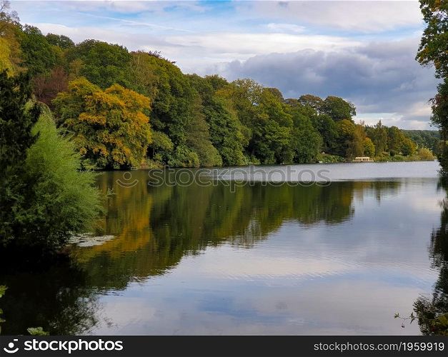 Beautiful autumn landscape of trees foliage and a Pond in West Yorkshire outside Leeds in the United Kingdom