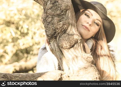 Beautiful autumnal woman in park. Young beauty woman wearing stylish autumnal clothes relaxing in park. Portrait of fashionable caucasian girl student resting on air.