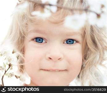 Beautiful baby and blossoming spring flower