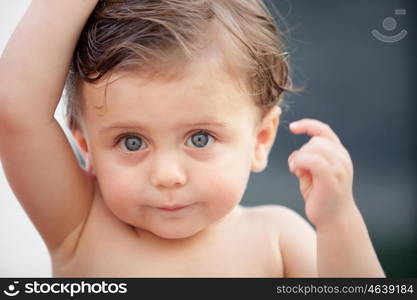 Beautiful baby one years old outside with wet hair