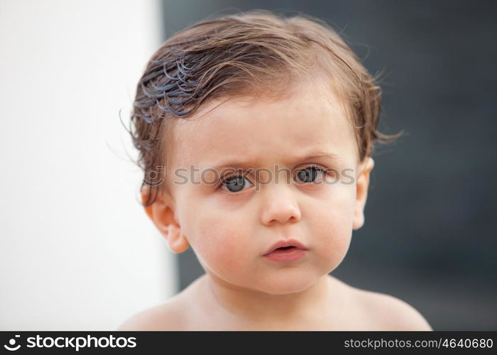 Beautiful baby one years old outside with wet hair