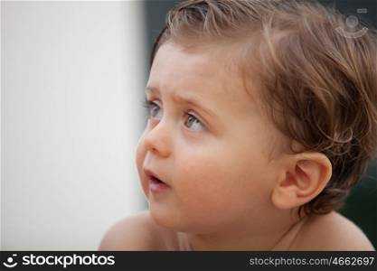 Beautiful baby one years old outside with wet hair