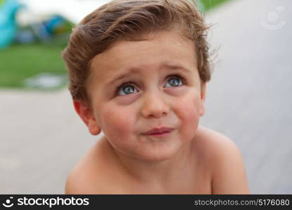 Beautiful baby two years old outside with wet hair