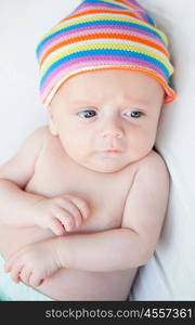 Beautiful baby with a colourful headscarf and blue eyes