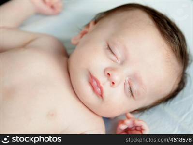 Beautiful baby with blue cap sleeping peacefully