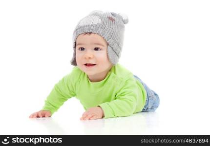 Beautiful baby with wool hat lying on the floor isolated