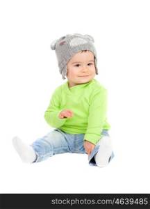 Beautiful baby with wool hat sitting on the floor isolated
