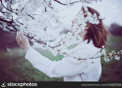 beautiful background. flowering tree and female hand